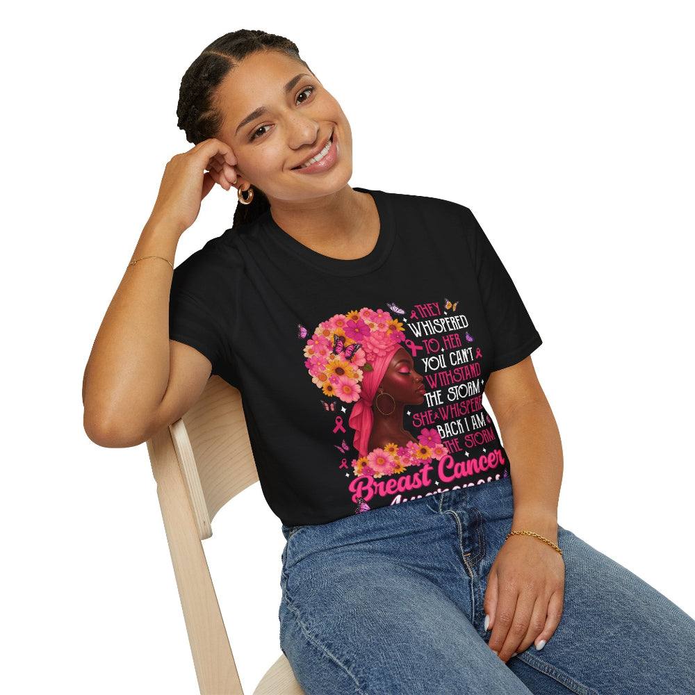 Woman wearing a black t-shirt with a colorful design and text, sitting on a chair.