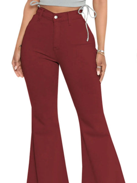 Maroon flared pants worn by a person on a white background