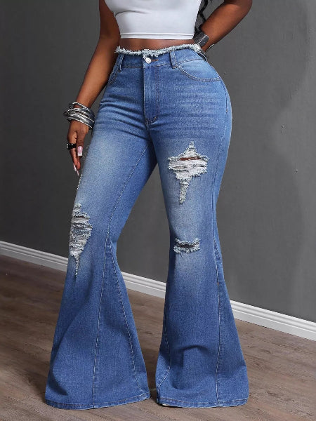 Person wearing blue flared jeans with a gray background