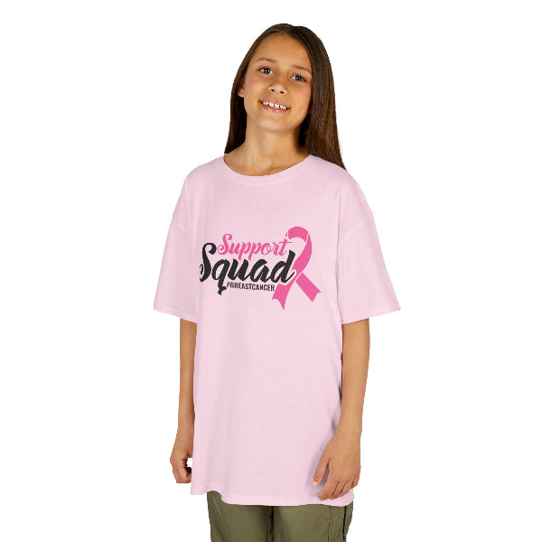 Young girl wearing a pink 'Support Squad' t-shirt with a pink ribbon on a white background