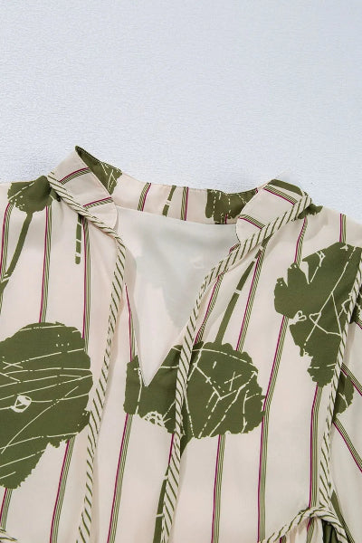 Close-up of a shirt with green leaf pattern on a light background
