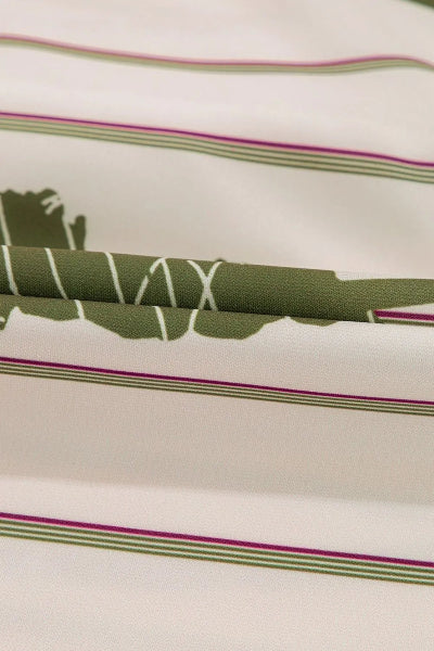 Close-up of fabric with green and purple striped pattern on a beige background