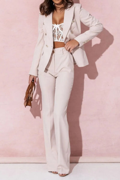 Woman wearing a white suit with a pink background