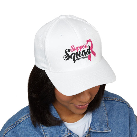 White cap with 'Support Squad' and pink ribbon design worn by a person.