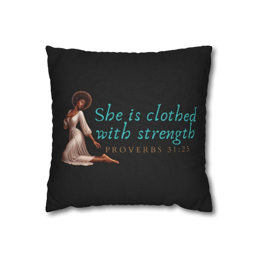 Black pillow with a design of a woman in a white dress and text 'She is clothed with strength Proverbs 31:25' on a white background.